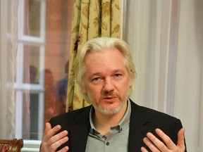 WikiLeaks founder Julian Assange gestures during a news conference at the Ecuadorian embassy in central London Aug. 18, 2014.