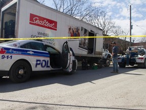 An Ottawa police cruiser sits wedged up against a milk truck, and heavily damaged, after a pursuit and hit and run in the downtown Friday morning. Cops finally got it stopped along Cathcart St. (JOEL WATSON Ottawa Sun)