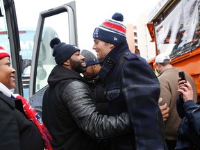 Tom Brady, the New England Patriots quarterback and Super Bowl MVP, gives Patriots cornerback Darrelle Revis a hug after the New England Patriots Super Bowl XLIX victory parade in Boston, Massachusetts February 4, 2015.  (REUTERS/Katherine Taylor)