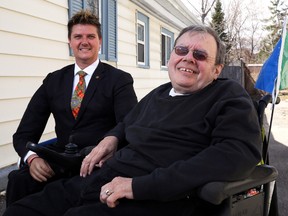 Luke Hendry/The Intelligencer 
John Cairns, left, founder of the Wheelchair of Hope Foundation, sits with Belleville's Don Phillips outside Phillips' home Thursday. The foundation has pledged to subsidize Phillips' commuting costs to his job, during which he pays for rides in a wheelchair-accessible van.