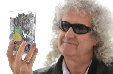 Brian May, guitarist with British rock band Queen, holds political campaign badges during a photo op on the seafront at Brighton in southern England, April 13, 2015. May, a founder member of the Common Decency political movement, was showing his backing for Green Party Member of Parliament Caroline Lucas, ahead of the British general election on May 7. (REUTERS/Toby Melville)