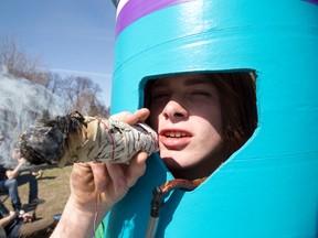 Chris Kirkland dressed up as "Bong Man" and sported a fake giant joint during 420 protests at Victoria Park in London, Ont. on Sunday April 20, 2014. (DEREK RUTTAN, The London Free Press)