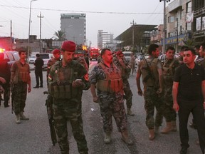 Kurdish security forces gather at the site of a bomb attack in Erbil, the capital of Iraq's Kurdistan region, April 17, 2015. A car bomb killed three people on Friday outside the U.S. consulate in Erbil, the capital of Iraq's Kurdistan region, a ally of Washington in the war against Islamic State, which claimed the attack. No U.S. personnel were hurt in the blast, according to the U.S. State Department, which said a "vehicle-borne improvised explosive device" exploded right outside the entrance to the heavily fortified compound. REUTERS/Stringer