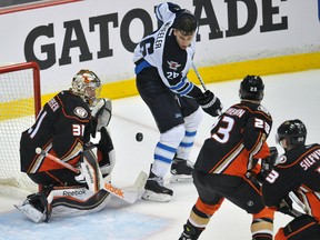 Jets right-winger Blake Wheeler tries to pounce on a rebound after losing his helmet during Thursday's series opener in Anaheim.