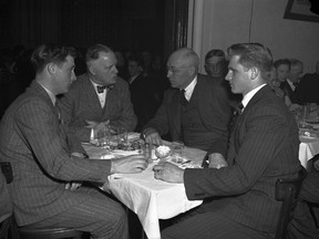 Two young aces from Wardsville flank a pair of older baseball pros as Lewis Fisher, left, Mooney Gibson, Harry O?Neill and Harry Fisher share a table at a baseball night early in 1948 at Thamesville. Gibson and O?Neill had both starred in the bigs. The Fishers were starting their careers. (London Free Press negative collection/Western Archives)