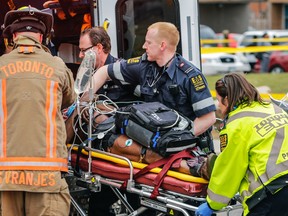 Five people were rushed to hospital with gunshot wounds after shots rang out at a townhouse unit on Driftwood Ave. in Toronto, April 16, 2015. (DAVE THOMAS/Postmedia Network)