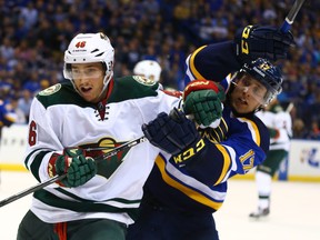 Jared Spurgeon of the Minnesota Wild (left) fends off Blues’ Jaden Schwartz during Game 1 of their Western Conference quarterfinal series at the Scottrade Center in St. Louis on Thursday. Minnesota was able to neutralize the Blues’ physicality with speed in the opener and will look to do so again this afternoon. (AFP/PHOTO)