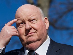 Suspended senator Mike Duffy scratches his eyebrow while waiting for his car at the courthouse in Ottawa on April 14, 2015. (Joel Watson/PostMedia Network)