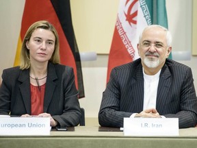 European Union High Representative Federica Mogherini, left, and Iranian Foreign Minister Javad Zarif wait for a meeting with officials from P5+1, the European Union and Iran at the Beau Rivage Palace Hotel in Lausanne March 31, 2015. (REUTERS/Brendan Smialowski/Pool)