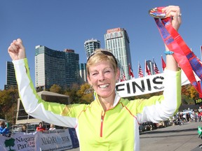 Paula Wiltse of Brockville celebrates after winning the women's open race at the Niagara International Marathon in October 2012. (Postmedia Network file photo)