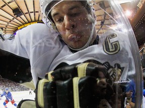 Sidney Crosby gets hit into the glass during the first period against the Ranges in Game 1. (afp)