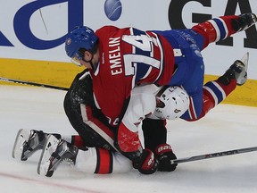 Ottawa Senators Curtis Lazar gets hilt by Montreal Canadiens Alexi Emelin during first period action at the Bell Centre in Montreal Friday April 17,  2015.  Tony Caldwell/Postmedia Network