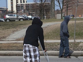 One of the victims of the shooting on Driftwood Ave. moves around on crutches on April 17, 2015.  (Chris Doucette/Toronto Sun)