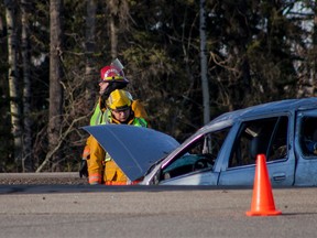Whitecourt firefighters investigate the scene of a vehicle rollover that happened on the eastbound lanes between Whitecourt, Alta. and the Eagle River Casino early in the evening on on Friday April 17, 2015. Adam Dietrich/Whitecourt Star/Postmedia Network