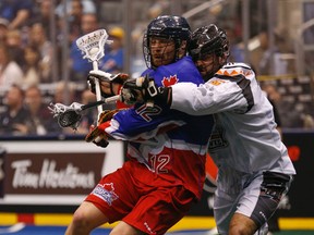 Kevin Crowley of the Rock (left) gets wrapped up by New England Black Wolves’ Mike Manley on Friday night at the ACC. (JACK BOLAND/TORONTO SUN)