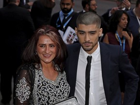 Former One Direction member Zayn Malik and his mother Trishia arrive at the fifth annual Asian Awards in the Grosvenor House Hotel, London April 17, 2015. REUTERS/Cathal McNaughton