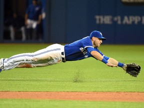 Toronto Blue Jays shortstop Steve Tolleson dives for a ball hit by Atlanta Braves shortstop Andrelton Simmons in the seventh inning Saturday at Rogers Centre. (Dan Hamilton/USA TODAY Sports)
