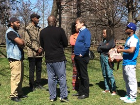 Mayor John Tory engages in a lively discussion with representatives from several community organizations Saturday. Antonius Clarke, of Fit Communities Services, is seen here second from the left. (Chris Doucette/Toronto Sun)
