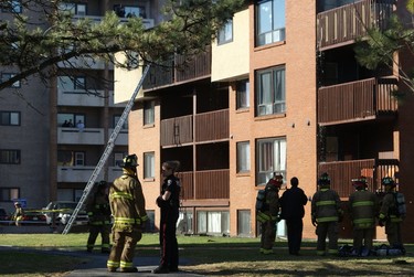 Firefighters at ground level work to contain a four-alarm apartment complex fire in West Ottawa on Saturday. Strong winds swept the flames quickly through the upper floor of the Deerfield Dr. townhome complex. (MICHAEL MILLER Submitted Image / Ottawa Sun)