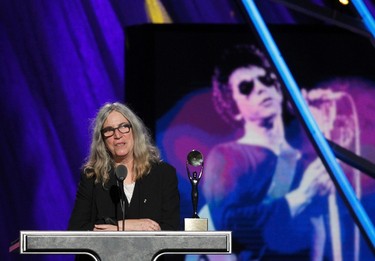 Singer Patti Smith inducts the late Lou Reed (shown in background image) during the 2015 Rock and Roll Hall of Fame Induction Ceremony in Cleveland, Ohio April 18, 2015. REUTERS/Aaron Josefczyk