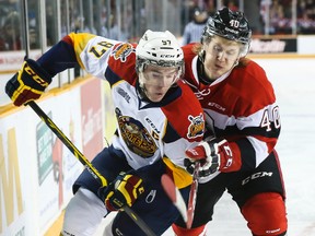 Connor McDavid of the Erie Otters battles with Ottawa 67's Alex Lintuniemi during OHL hockey action at the Arena at TD Place. February 1, 2015. Errol McGihon/Ottawa Sun/QMI Agency