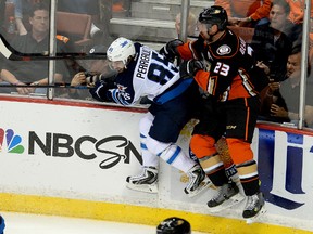Apr 18, 2015; Anaheim, CA, USA;  Anaheim Ducks defenseman Francois Beauchemin (23) and Winnipeg Jets center Mathieu Perreault (85) hit the boards in the second period of game two of the first round of the the 2015 Stanley Cup Playoffs at Honda Center. Mandatory Credit: Jayne Kamin-Oncea-USA TODAY Sports