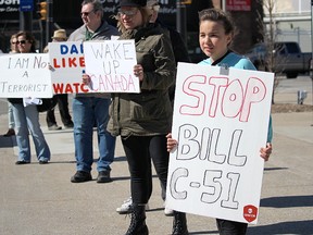 11-year-old Emma Plain was one of about 70 people at a rally against Bill C-51 in Sarnia Saturday. The demonstration against the Conservative government's proposed anti-terror legislation was one of several held concurrently across Canada. Tyler Kula/Sarnia Observer/Postmedia Network