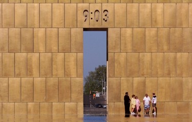A group of tourists stand under The Gates of Time while visiting the Oklahoma City National Memorial, in this file photo takekn April 20, 2000. The national memorial, which has 168 chairs representing each of the victims of the 1995 bombing of the federal building, opened to the public April 19 following public and private ceremonies.  Sunday marks the 20th anniversary of the bombing - the nation's worst act of domestic terrorism.  Anti-government militant Timothy McVeigh, who conceived and carried out the attack, was executed in 2001. His accomplice Terry Lynn Nichols is in prison for life.  REUTERS/Staff/Files