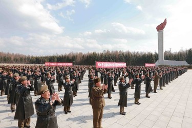 Korean People's Army pilots who have completed a tour of battle sites in the area of Mt Paektu applaud during a visit by North Korean leader Kim Jong Un in this undated photo released by North Korea's Korean Central News Agency (KCNA) on April 19, 2015. REUTERS/KCNA