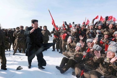 North Korean leader Kim Jong Un greets Korean People's Army pilots during a visit to the summit of Mt Paektu April 18, 2015, in this photo released by North Korea's Korean Central News Agency (KCNA) on April 19, 2015. REUTERS/KCNA