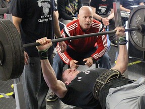 McKenzie Turner lifts 345 pounds at Ironworks Saturday, during competition at the gym's annual Fitness Challenge. Looking on is competition judge Craig Davies. The bench press and fitness event this year brought in $14,000 for Pathways Health Centre for Youth. Tyler Kula/Sarnia Observer/Postmedia Network