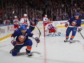 John Tavares #91 of the New York Islanders celebrates his game winning goal at 15 seconds of the overtime against the Washington Capitals in Game Three of the Eastern Conference Quarterfinals during the 2015 NHL Stanley Cup Playoffs at the Nassau Veterans Memorial Coliseum on April 19, 2015 in Uniondale, New York. (Bruce Bennett/Getty Images/AFP)