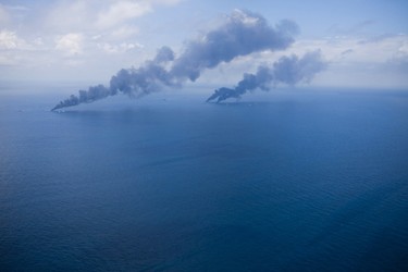 Oil is burned off the surface of the water near the source of Deepwater Horizon oil spill where BP will begin to test a new cap placed over the leak in the Gulf of Mexico off the Louisiana coast July 13, 2010. REUTERS/Lee Celano