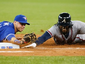 Justin Smoak makes a double play after catching an Alberto Calapso line drive and than diving back to first to get Cameron Maybin out in Toronto, Ont. on Sunday April 19, 2015. (Stan Behal/Toronto Sun/Postmedia Network)