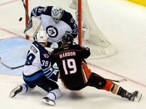 Apr 18, 2015; Anaheim, CA, USA;  Winnipeg Jets goalie Ondrej Pavelec (31) blocks a shot as defenseman Tobias Enstrom (39) defends Anaheim Ducks left wing Patrick Maroon (19) in the third period of game two of the first round of the the 2015 Stanley Cup Playoffs at Honda Center. Ducks won 2-1. Mandatory Credit: Jayne Kamin-Oncea-USA TODAY Sports