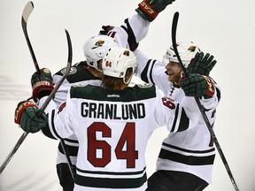 Minnesota Wild center Mikael Granlund (64) celebrates with teammates after scoring an empty net goal against the St. Louis Blues in the third period in game one of the first round of the the 2015 Stanley Cup Playoffs at Scottrade Center. The Minnesota Wild defeat the St. Louis Blues 4-2. (Jasen Vinlove-USA TODAY Sports)