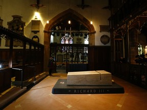 Members of the media photograph the tomb of King Richard III in Leicester Cathedral, central England, March 27, 2015.  King Richard III, the medieval English monarch whose remains were found under a car park three years ago, was reburied yesterday, nearly 530 years after he was slain in battle.  REUTERS/Darren Staples