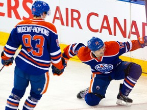 Edmonton Oilers Jordan Eberle (14) celebrates his goal on the Columbus Blue Jackets as Ryan Nugent-Hopkins (93) looks on during first period NHL action at Rexall Place in Edmonton, Alta. on Tuesday, Nov. 19, 2013. Amber Bracken/Edmonton Sun