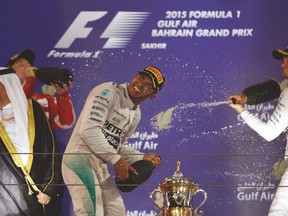 Third-placed Nico Rosberg (right) sprays champagne to race-winner and Mercedes teammate Lewis Hamilton after the Briton won the Bahrain F-1 Grand Prix on Sunday. (REUTERS)