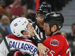 Ottawa Senators Chris Neil and Montreal Canadiens Brendan Gallagher are separated by an official during NHL hockey action at the Canadian Tire Centre in Ottawa, Ontario on April 19, 2015. Errol McGihon/Ottawa Sun/QMI Agency