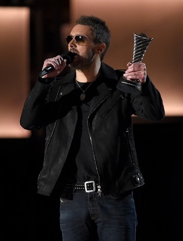 Musician Eric Church presents musician Kenny Chesney (not pictured) with the Milestone Award for First Fan-Voted ACM Entertainer Of The Year from onstage during the 50th Academy Of Country Music Awards at AT&T Stadium on April 19, 2015 in Arlington, Texas.   Ethan Miller/Getty Images for dcp/AFP