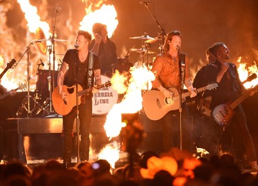 Recording artists Brian Kelley (L) and Tyler Hubbard of music group Florida Georgia Line perform onstage during the 50th Academy Of Country Music Awards at AT&T Stadium on April 19, 2015 in Arlington, Texas.   Cooper Neill/Getty Images for dcp/AFP