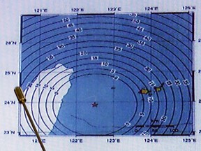 Japan Meteorological Agency's earthquake and volcano observations division director Koji Nakamura (not in picture) points on the map showing the quake centre (star mark) during a news conference in Tokyo April 20, 2015. A strong earthquake rattled Taiwan and small islands in the far south of Japan on Monday, official monitoring sites said, prompting a warning for a 1-metre tsunami for the Okinawa island chain.
REUTERS/Issei Kato