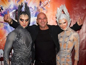 Guy Laliberte, centre, CEO of Cirque du Soleil, poses with performers as he attends the premiere of Michael Jackson The Immortal World Tour show by Cirque du Soleil in Montreal, October 2, 2011. (REUTERS/Christinne Muschi/Files)