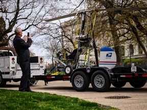 A man takes pictures of a gyro copter that was flown onto the grounds of the U.S. Capitol as it is towed from the west front lawn in Washington, in this file photo taken April 15, 2015. (REUTERS/James Lawler Duggan/Files)