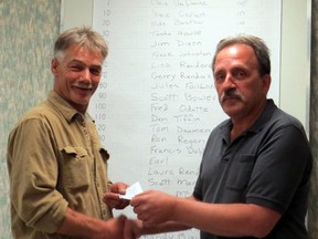 Submitted photo: Knights of Columbus member Francis Hermsen, right, presents the grand prize of $500 to Mike deBakker at The Knights of Columbus Stag 200 Steak BBQ held on April 17. The event is being hailed as a success with all 200 tickets sold and $400 dollars was raised for the Chatham-Kent Women's Centre. There were 26 cash prize winners.