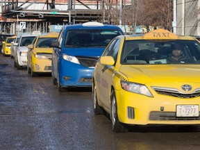Taxi drivers surround Edmonton City Hall during an anti-Uber protest, in Edmonton Alta., on Wednesday Jan. 15, 2015. (DAVID BLOOM/Edmonton Sun)