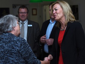 Christine Elliott speaks with Gail Kenney during a meet-and-greet reception in Kingston on Monday morning. Elliott is a candidate as leader of the Ontario Progressive Conservative party. (James Paddle-Grant/For The Whig-Standard)
