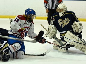 Kingston Voyageurs’ Adam Brady gets caught in front of Toronto Patriots goalie Mathew Robson during Game 6 of the Ontario Junior Hockey League Buckland Cup final at the Invista Centre on Monday night. The Voyageurs won 3-1 to force a Game 7 in the championship series Wednesday night in Toronto.  (James Paddle-Grant/For The Whig-Standard)