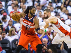 Jonas Valanciunas guards the Wizards' Nene during Game 1 of their series. (Ernest Doroszuk/Toronto Sun)